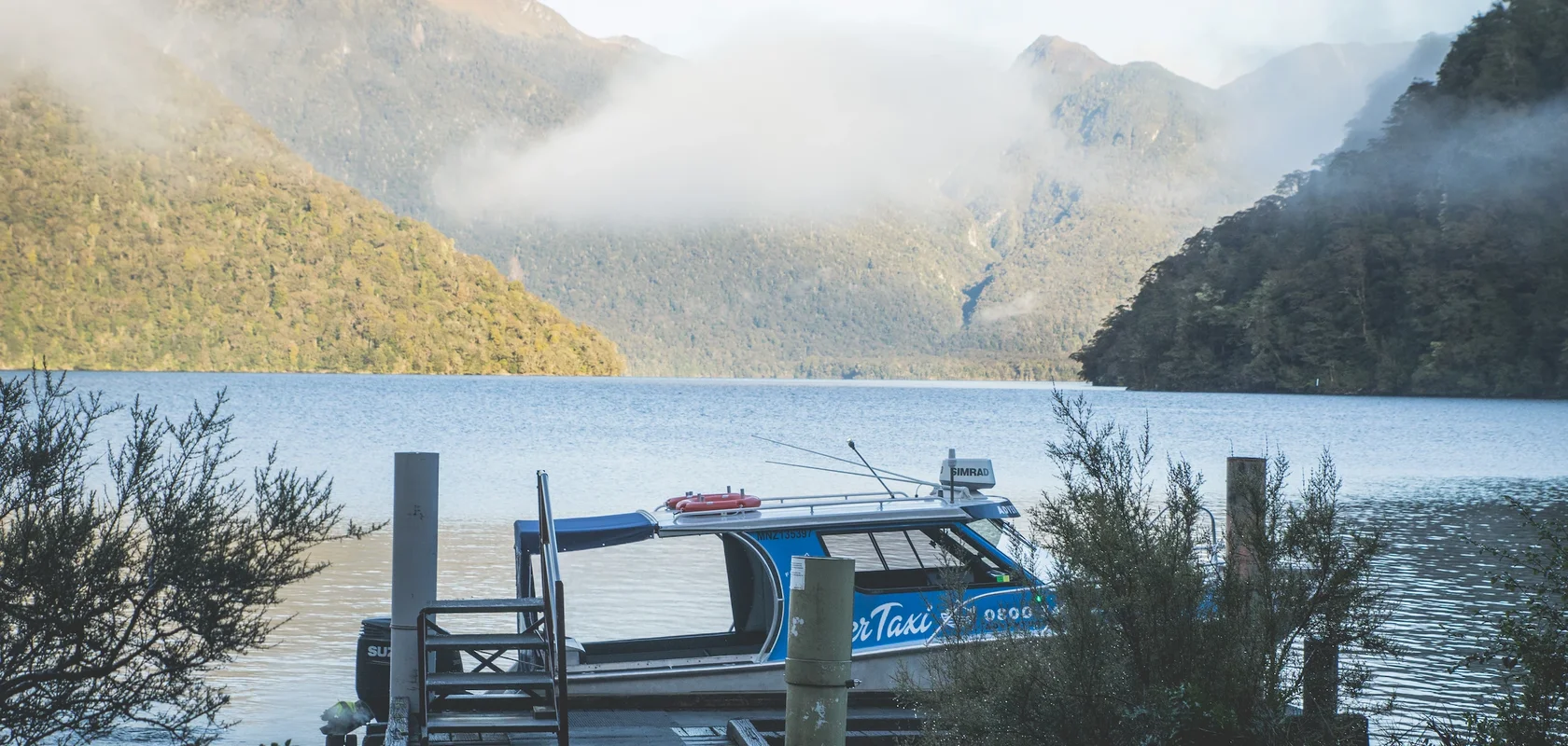 Water Taxi parked at wharf, Milford Track Transport Fiordland Outdoors