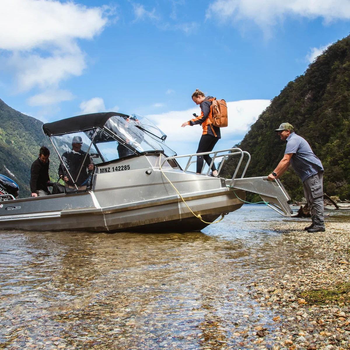 Hikers getting onboard the Lake Hankinson boat transport with Fiordland Outdoors