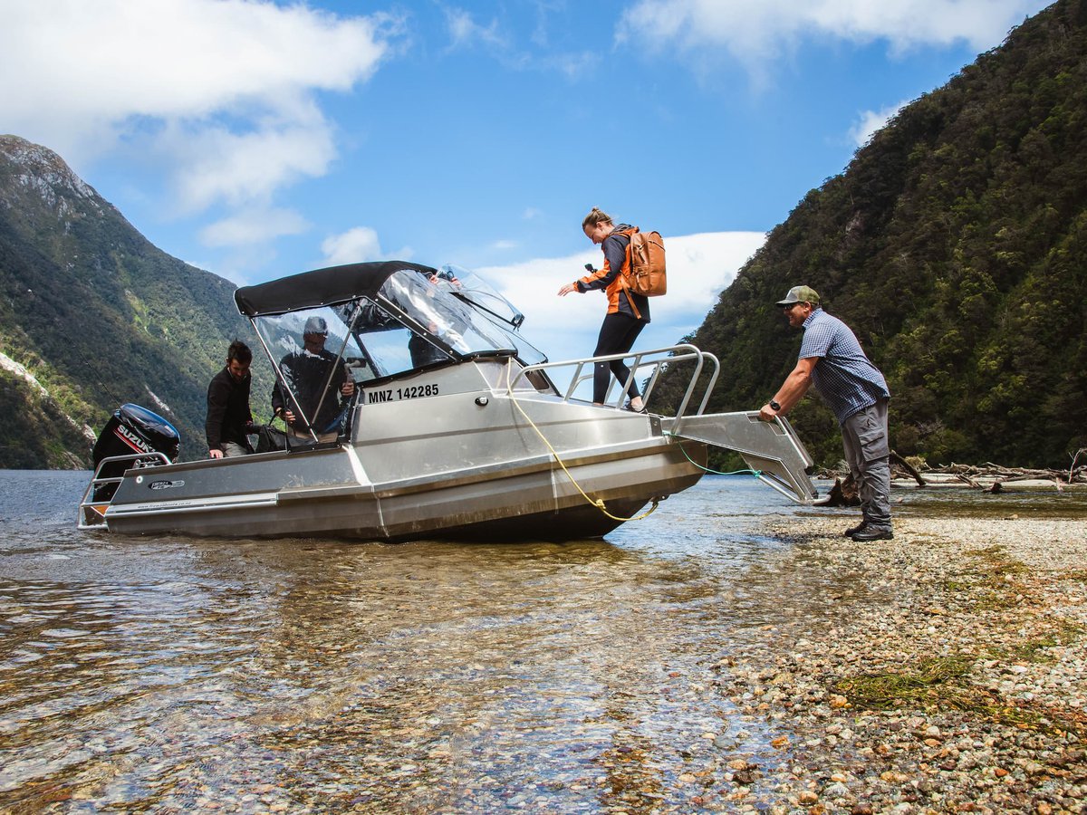 Hikers getting onboard the Lake Hankinson boat transport with Fiordland Outdoors