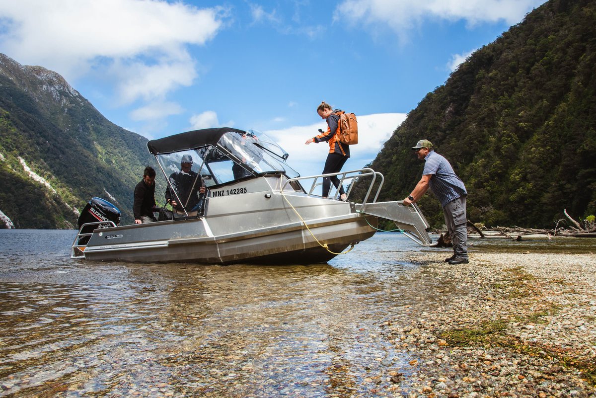 Hikers getting onboard the Lake Hankinson boat transport with Fiordland Outdoors