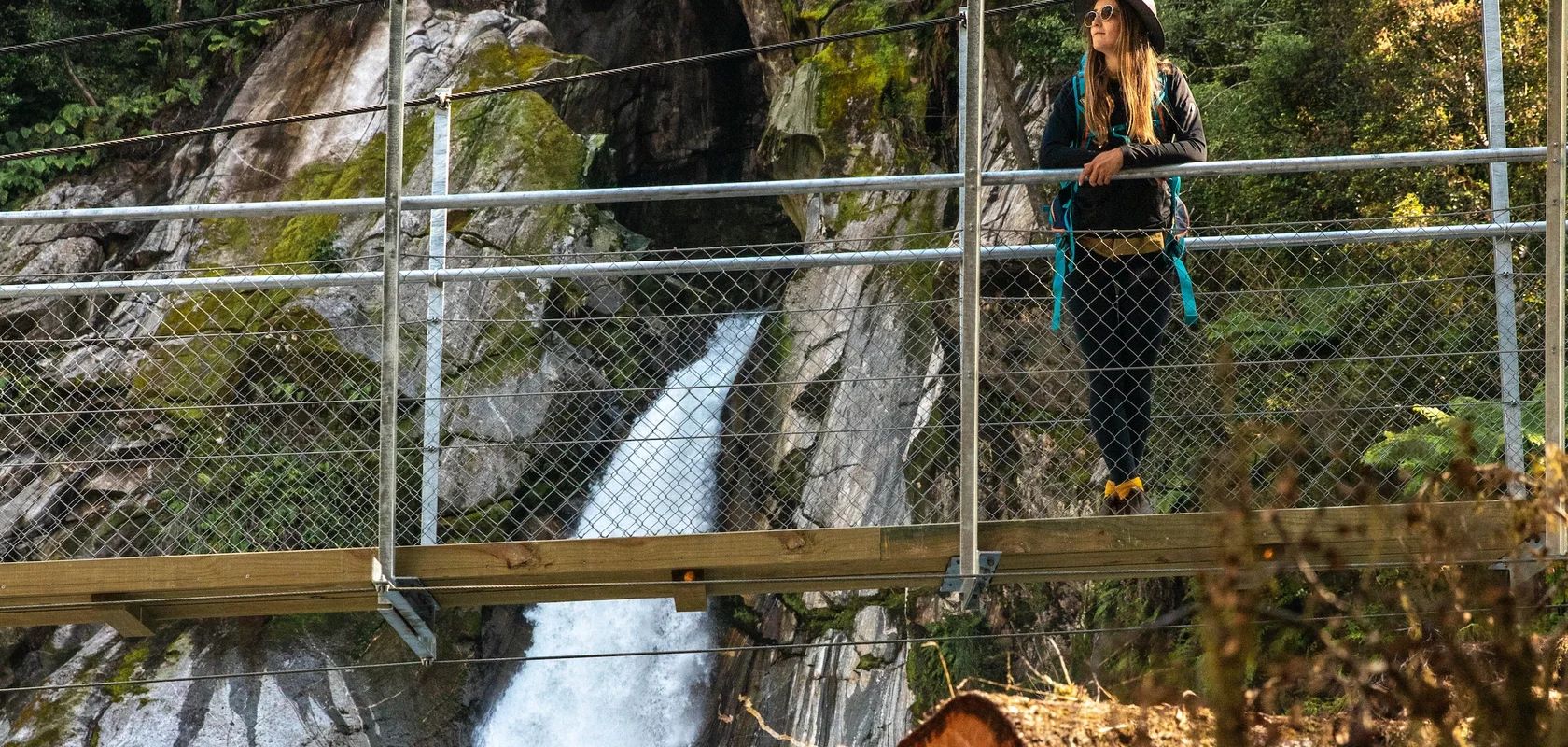 Standing on the bridge at Giant Gates Waterfall, Milford Track Day Hike. Fiordland Outdoors