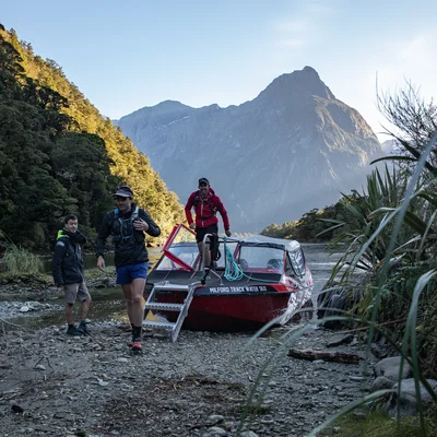 People getting off the Milford Track Water Taxi transport to start the track, Fiordland Outdoors