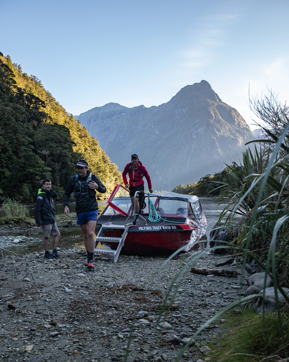 People getting off the Milford Track Water Taxi transport to start the track, Fiordland Outdoors Co